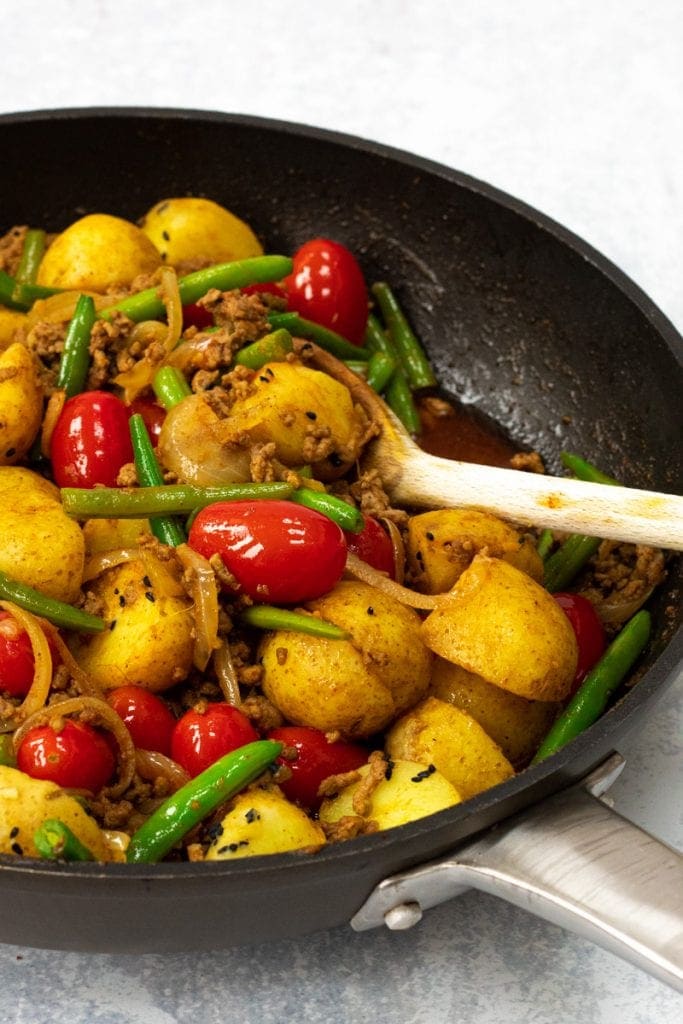 Bombay Lamb curry with potatoes,tomatoe and green beans in the pan