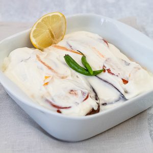 Serving dish with layers of aubergine in yogurt