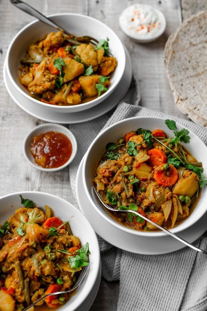 three bowls of Indian vegetable curry