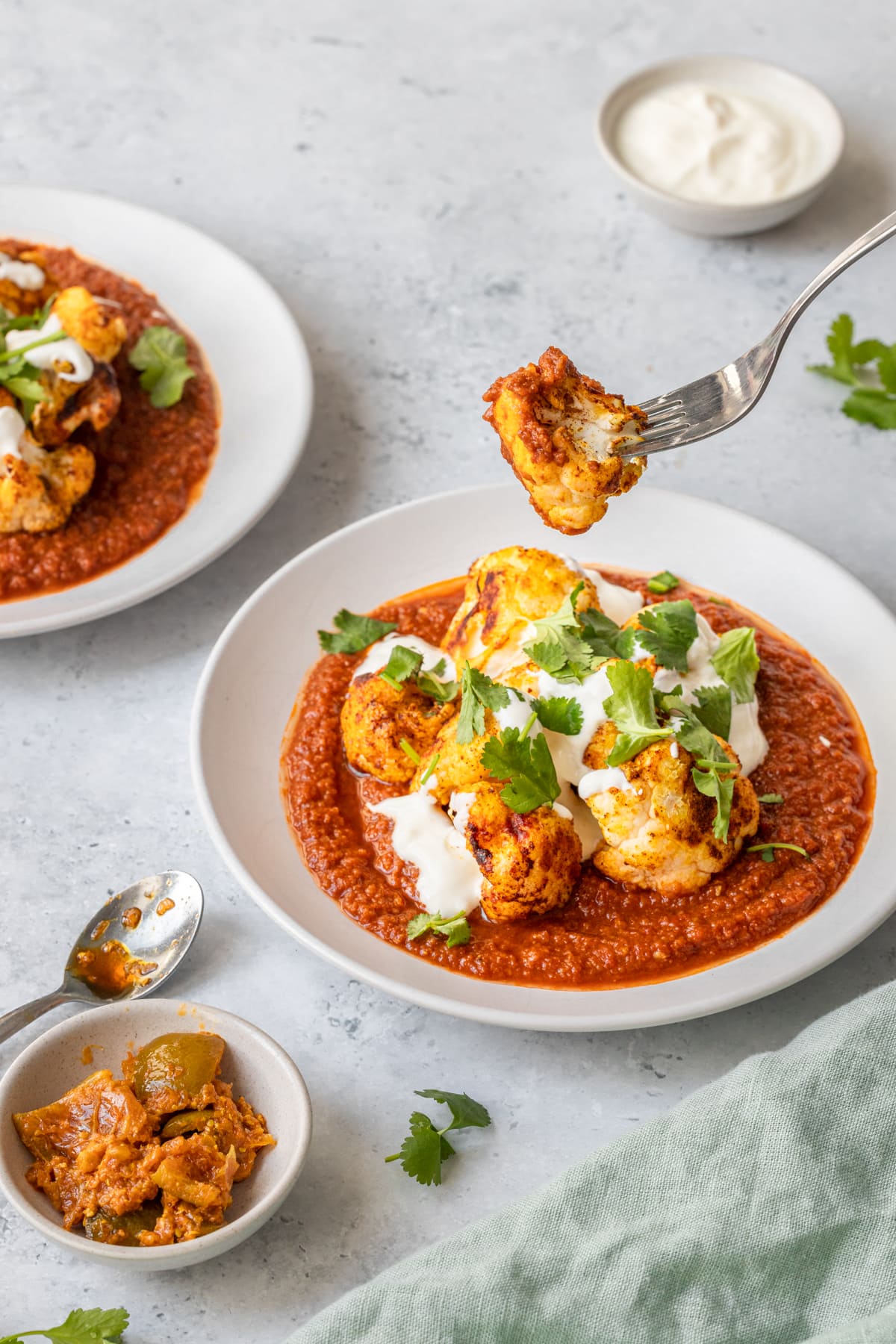 Roasted cauliflower curry with piece on a fork