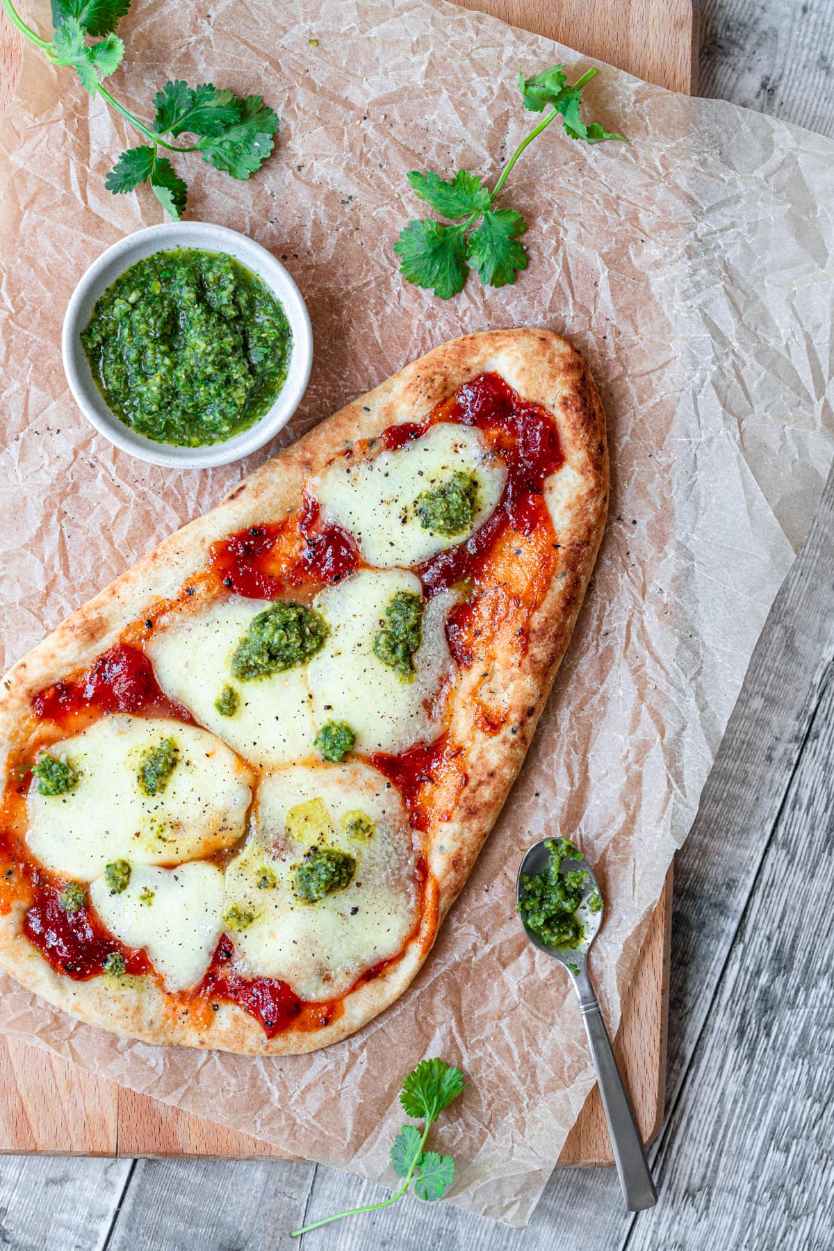 Naan bread pizza with coriander chutney drizzle
