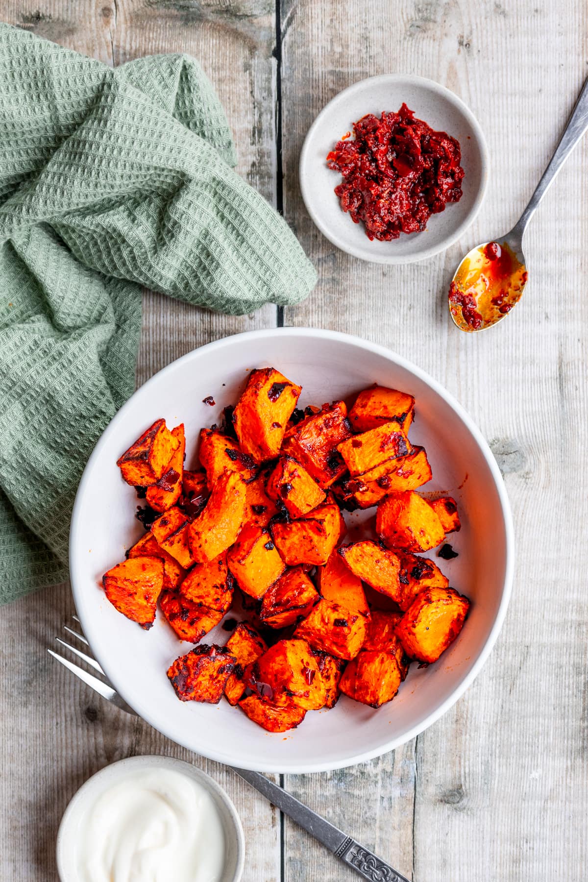 Bowl of air fried butternut squash with harissa