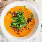 Bowl of turkish red lentil soup topped with herbs