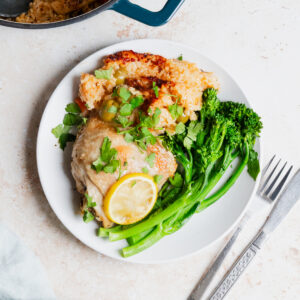 plate of Greek one pot chicken and rice with broccoli